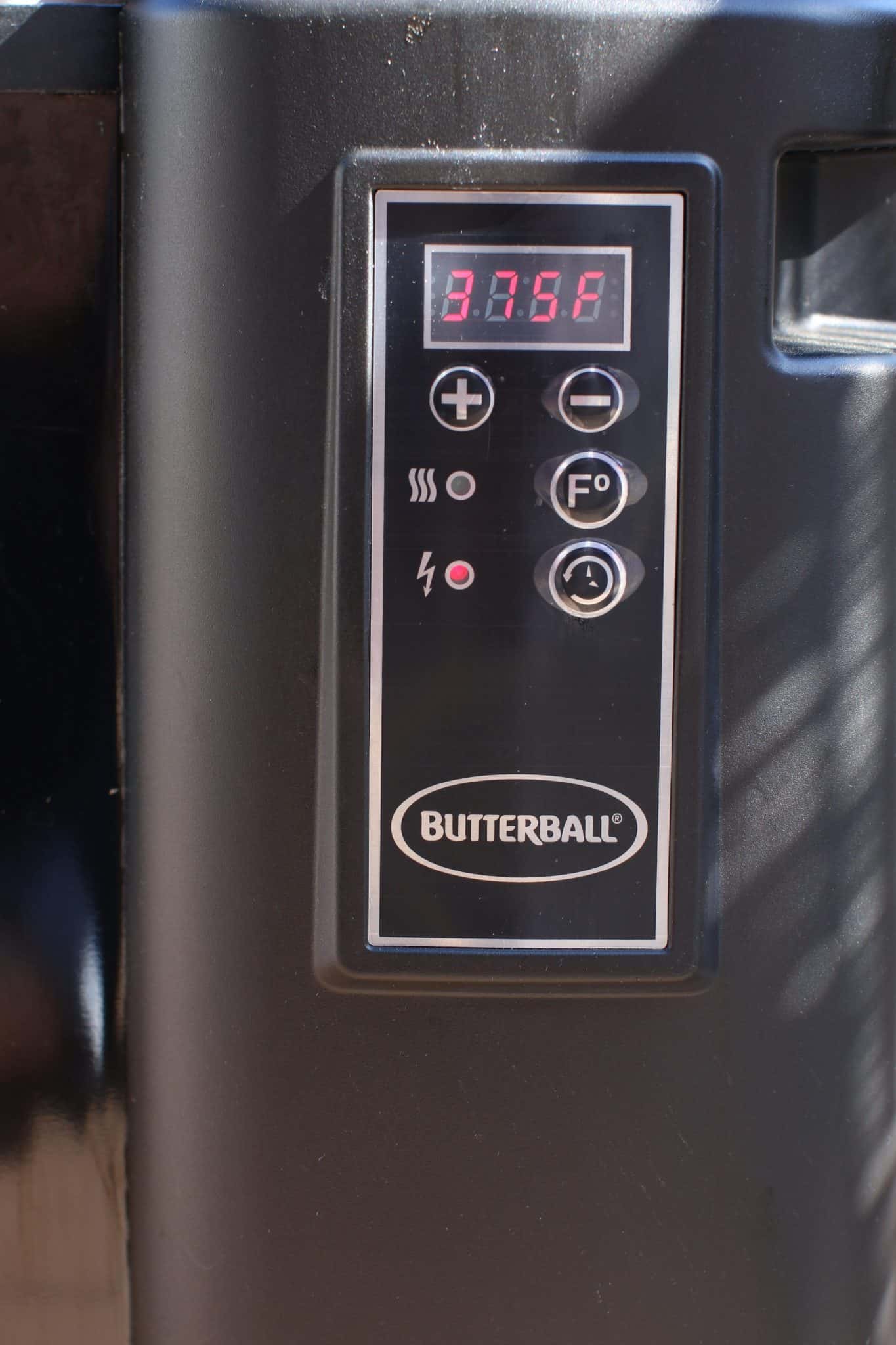 A digital temperature gauge on a turkey fryer showing 375F degrees. 