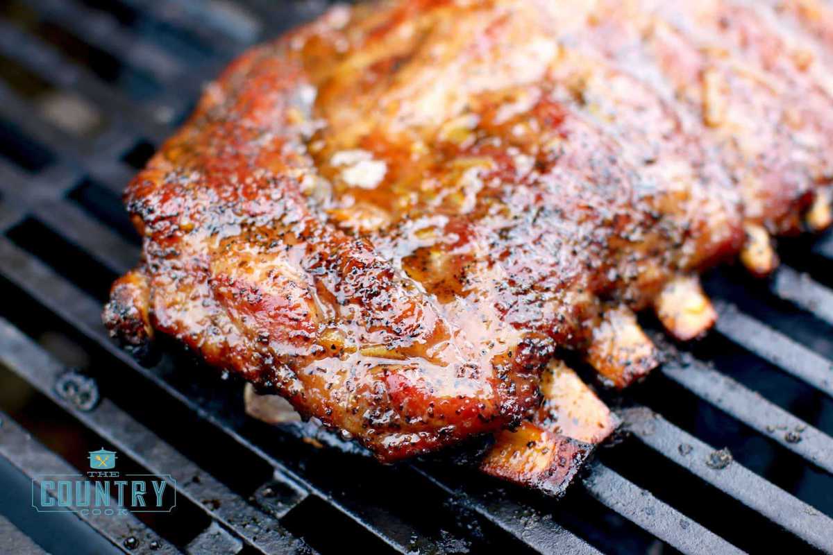 closeup photo of fully cooked pork ribs on a gas grill.