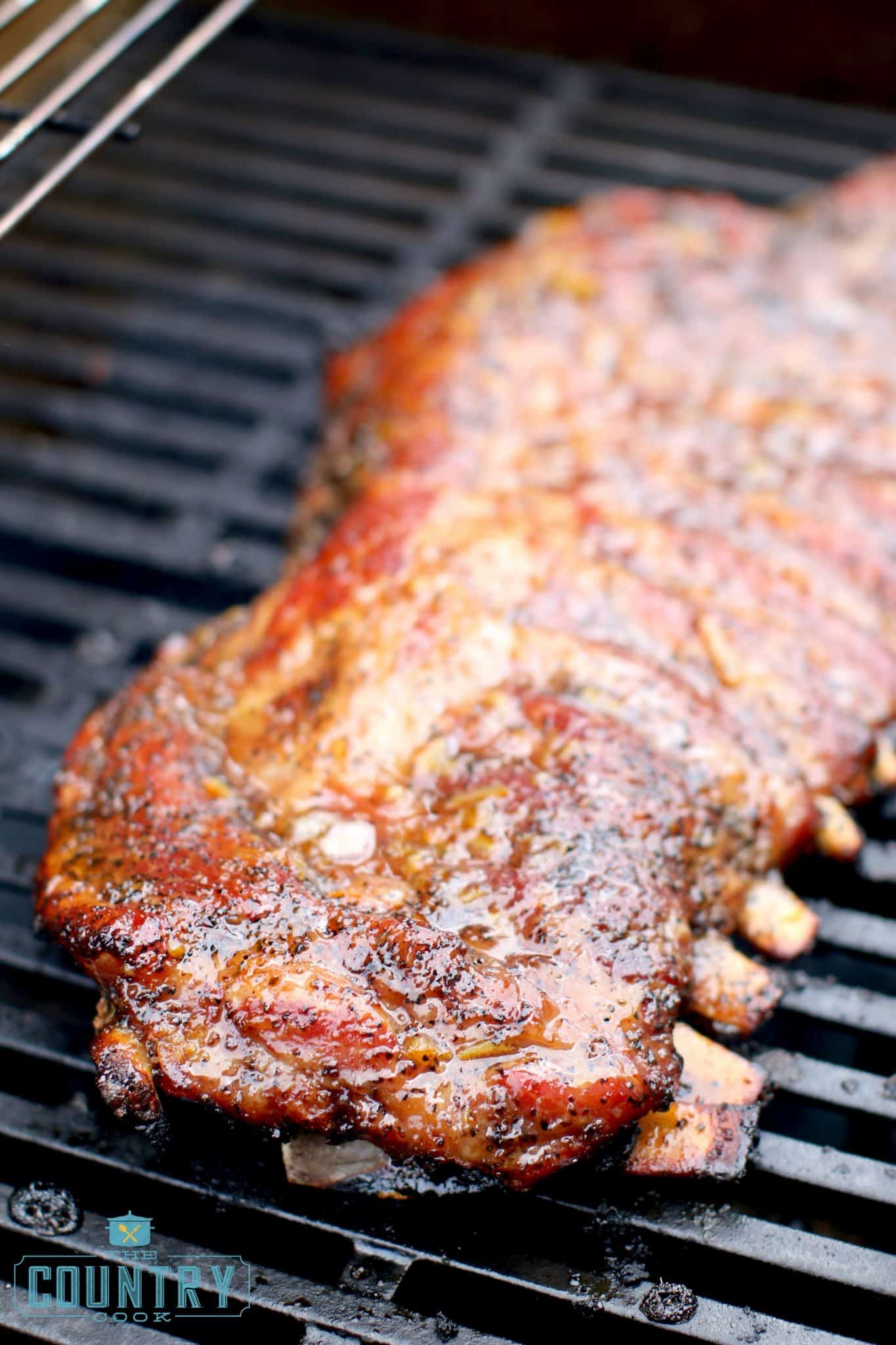 fully cooked pork ribs on a gas grill.