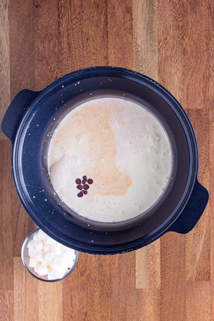 milk, sweetened condensed milk, heavy whipping cream and semisweet chocolate chips in a round slow cooker.