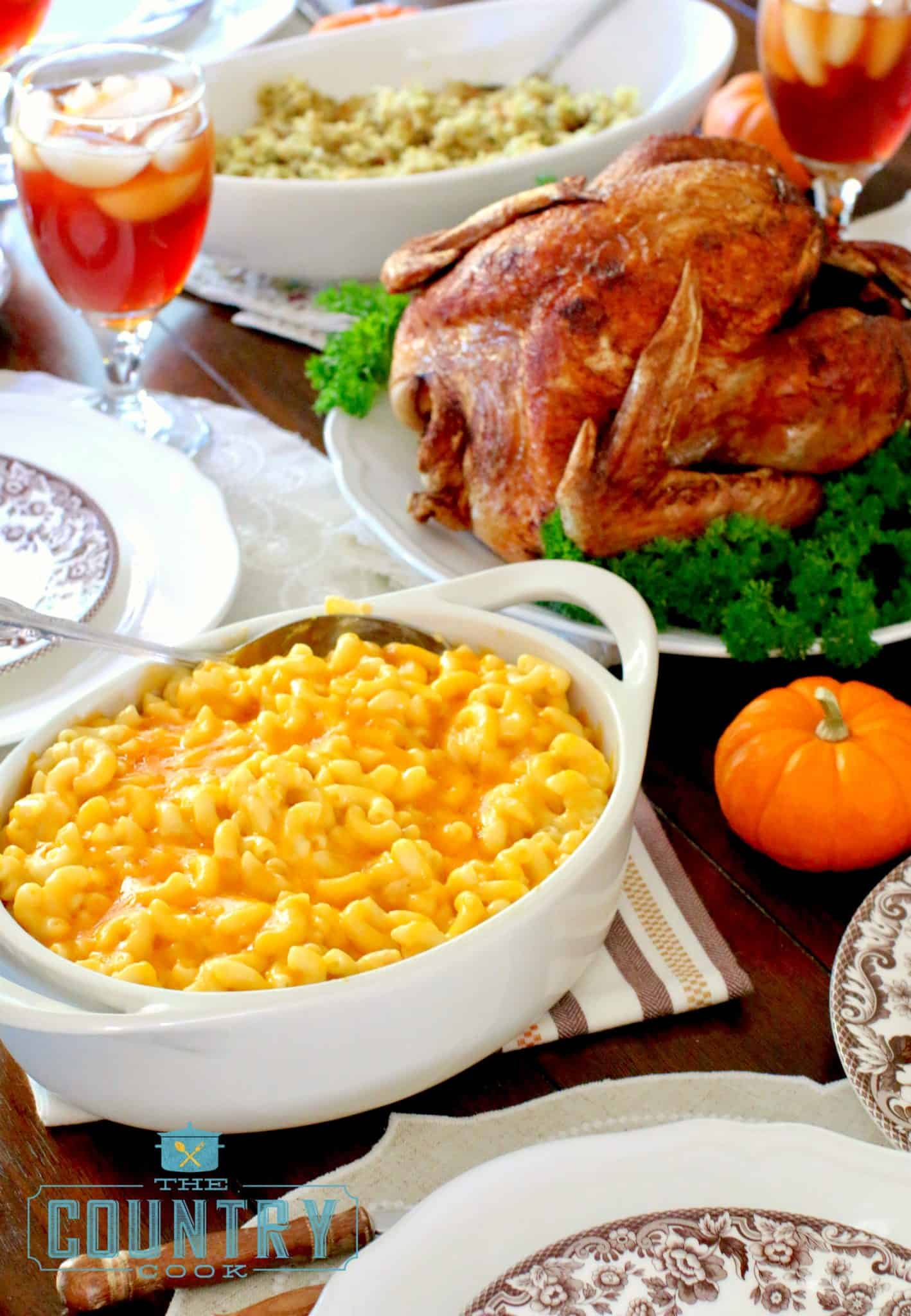 Thanksgiving Dinner shown displayed on a table with macaroni and cheese and fried turkey.