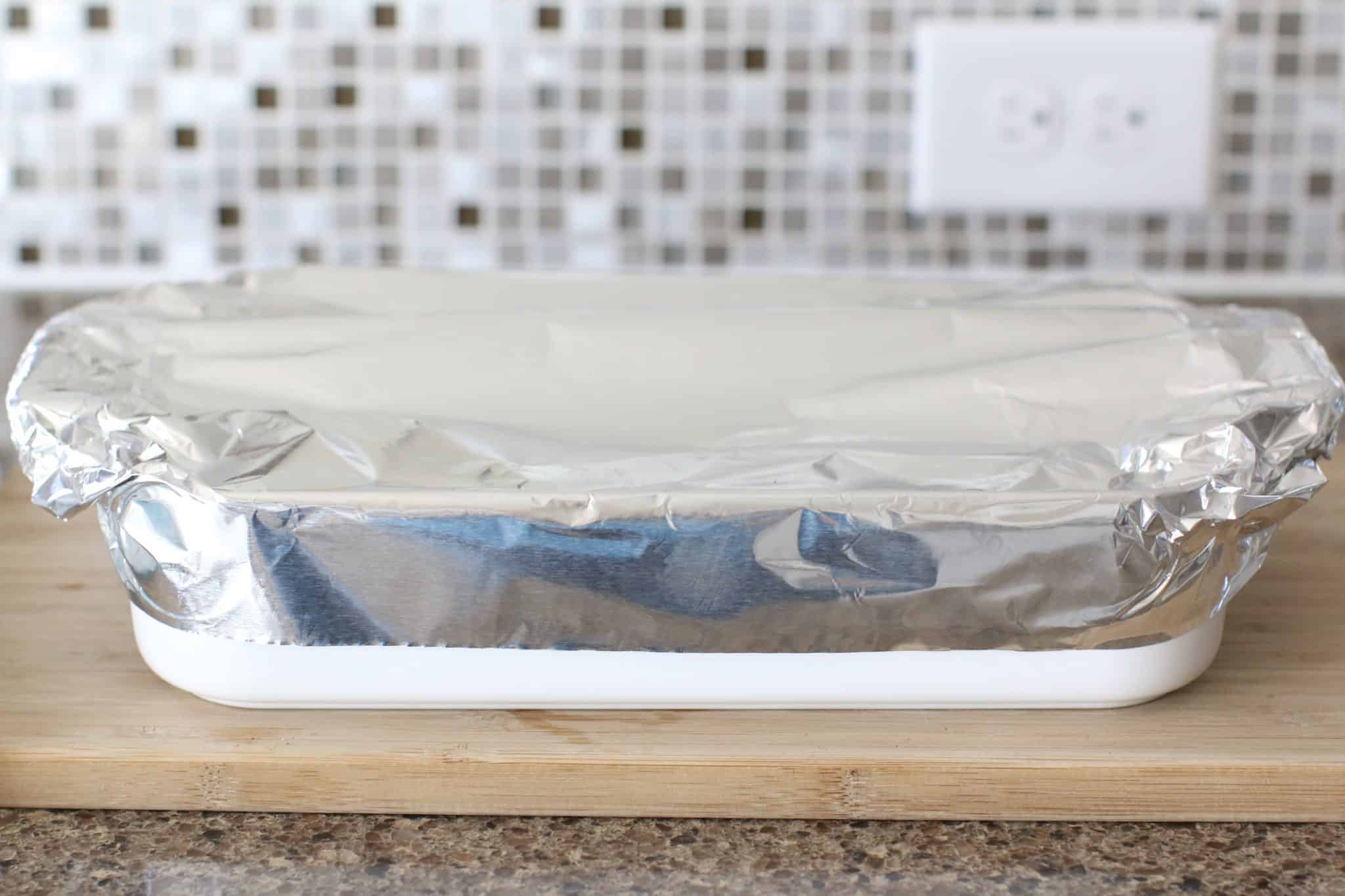 a baking dish shown covered with aluminum foil.