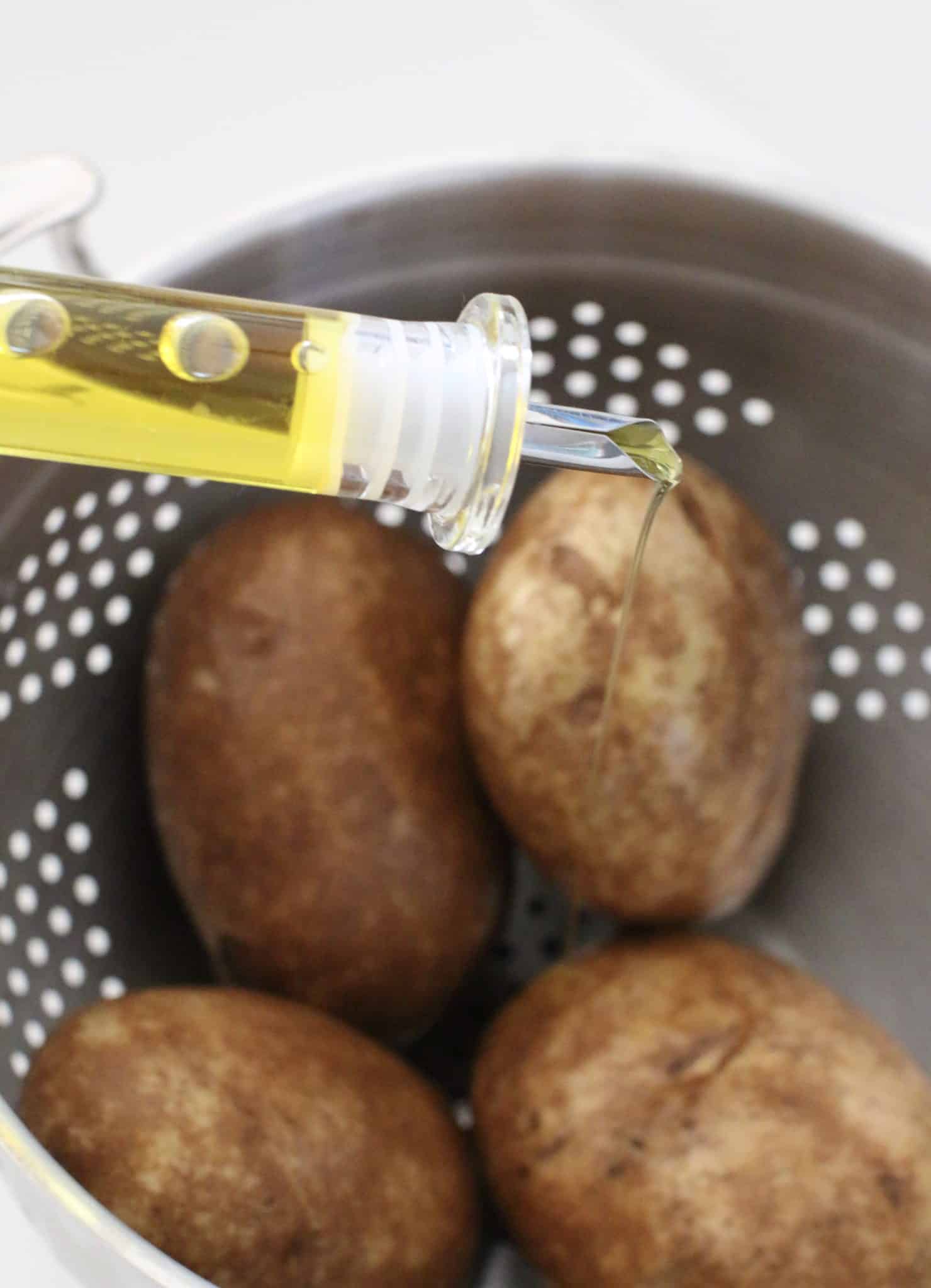 coating russet potatoes in olive oil.