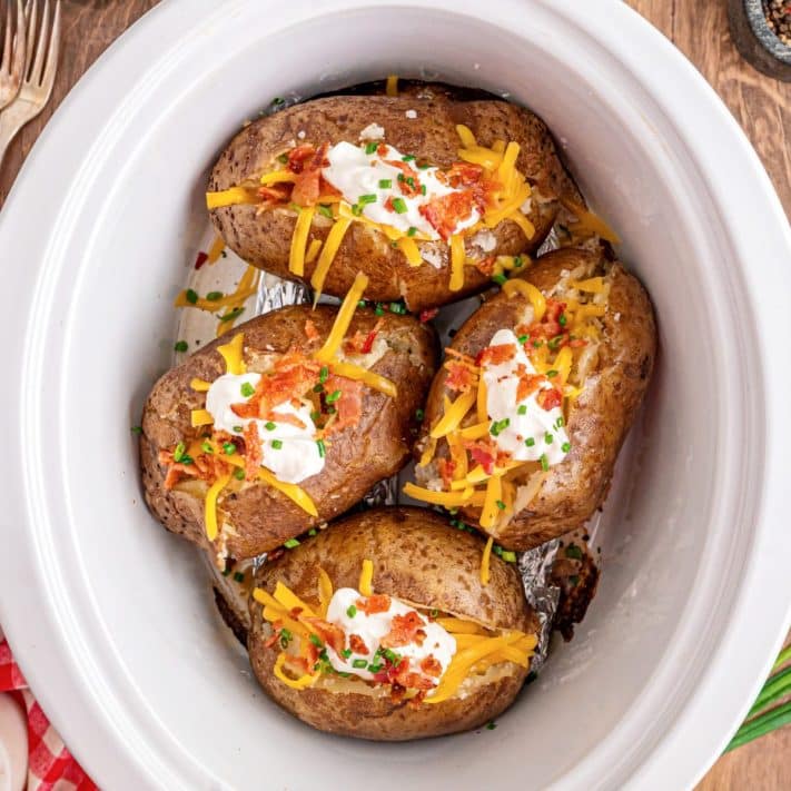 Some fully loaded Crock Pot Baked Potatoes with all the toppings.