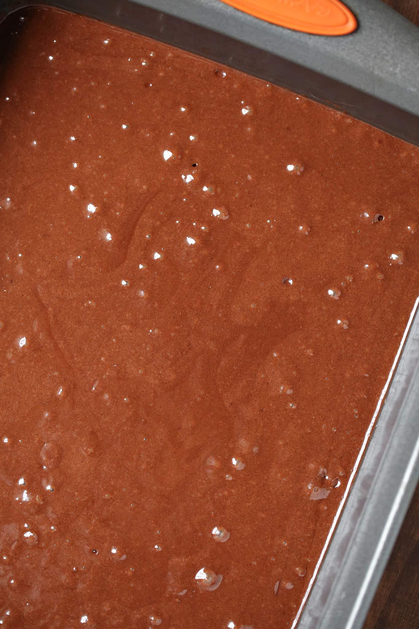 brownie batter poured into baking pan.