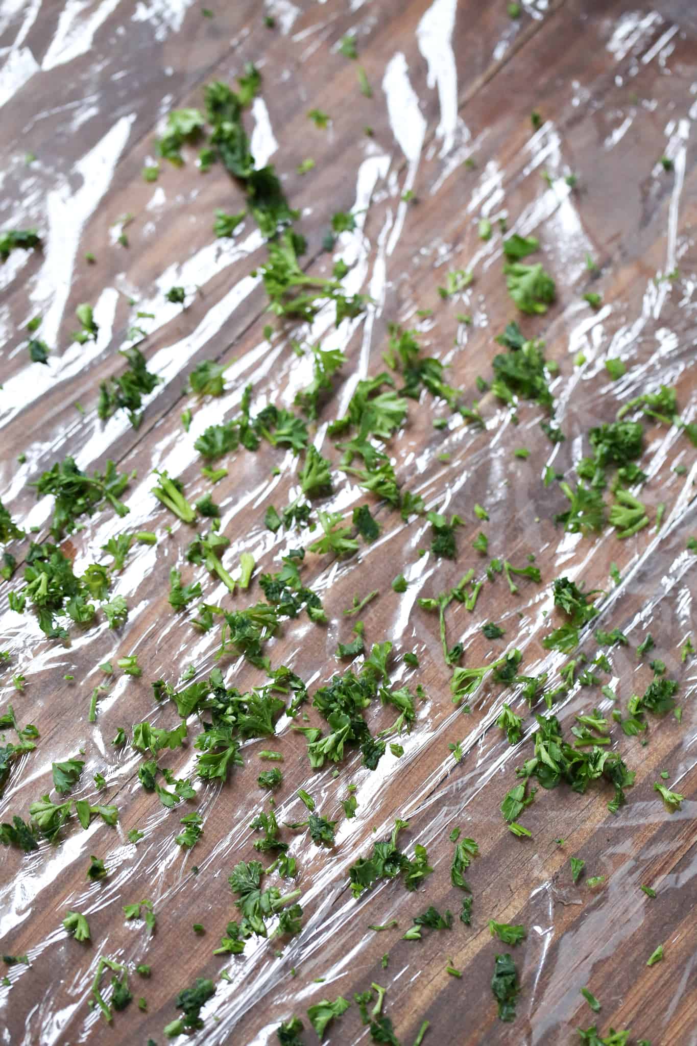 chopped parsley scattered on plastic wrap.