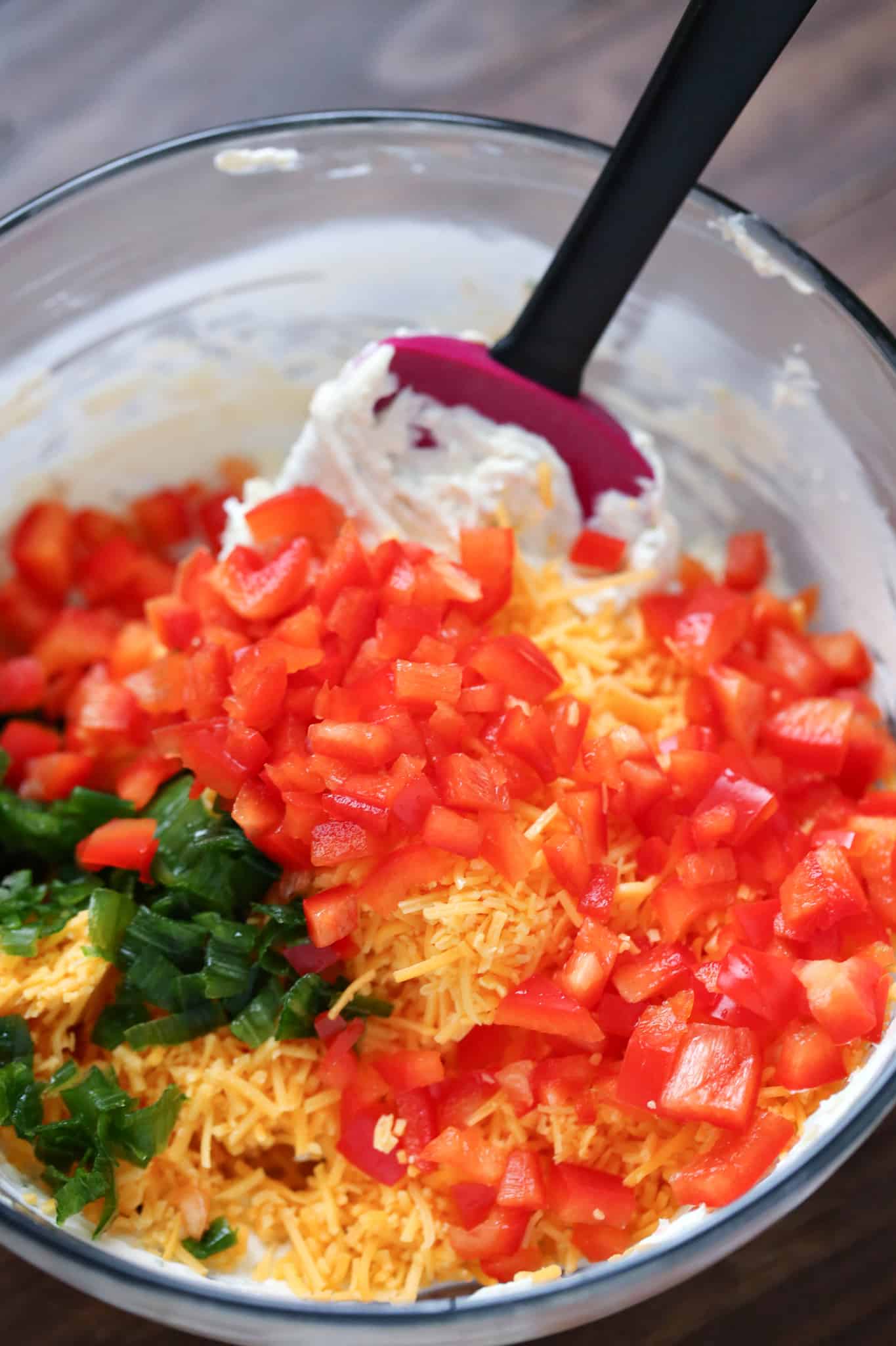 ranch dressing. diced red pepper, green onion and shredded cheddar cheese added to cream cheese mixture.