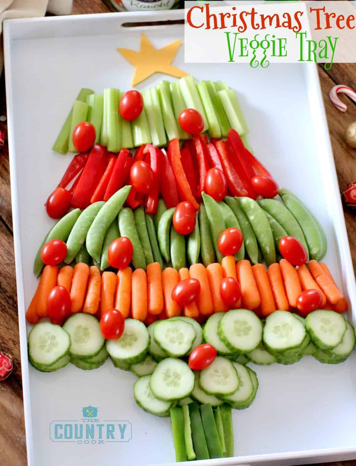 A vegetable tray shaped like a Christmas Tree on a white serving tray.