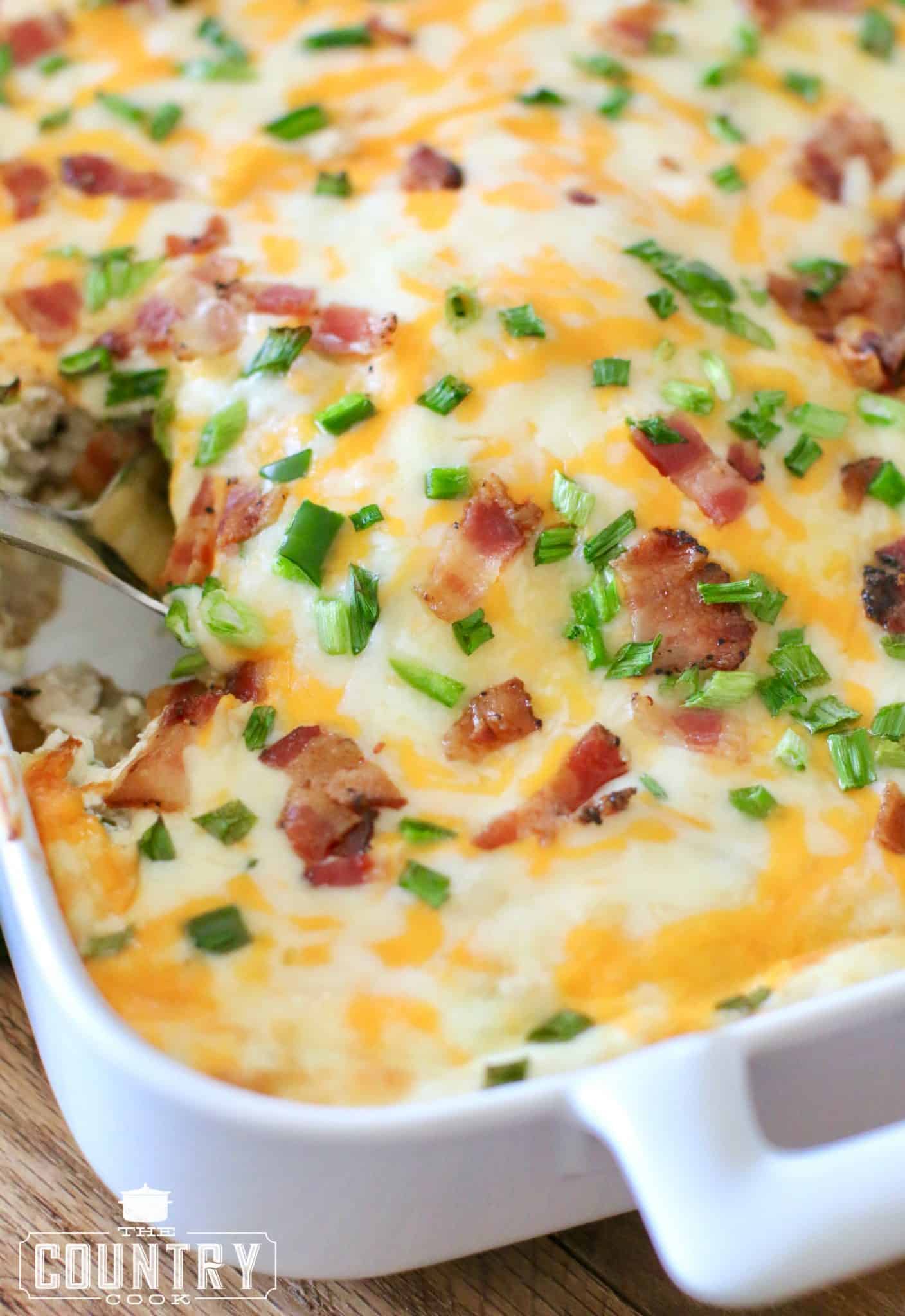 Jalapeno Popper Tater Tot Chicken Casserole shown with a large serving spoon scooping out a serving. 