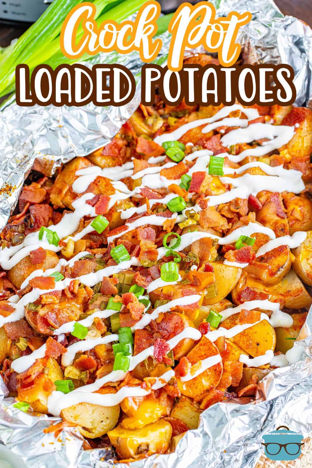 loaded potatoes in aluminum foil with the top drizzled with sour cream. 