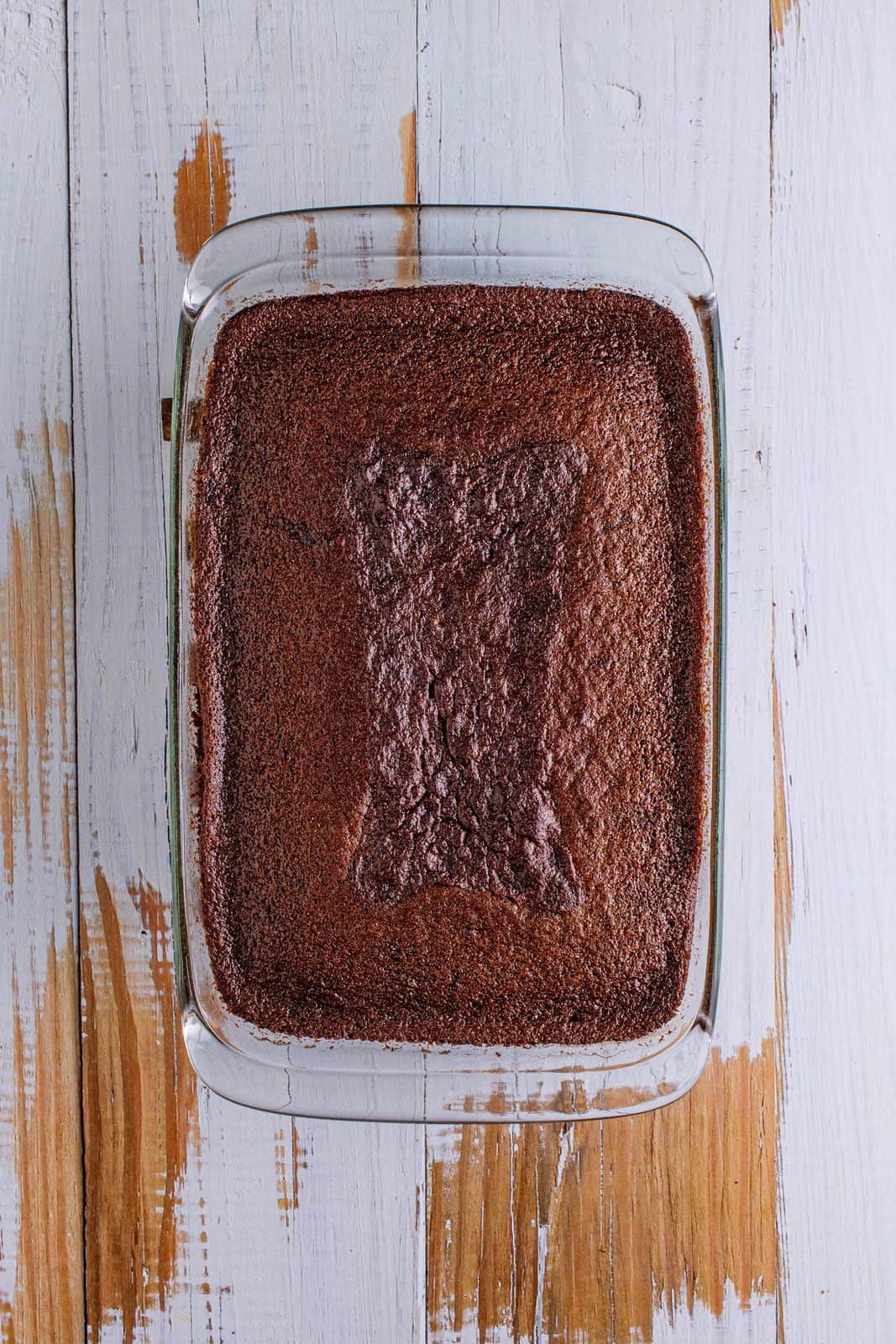 fully baked chocolate cake in a clear baking dish.