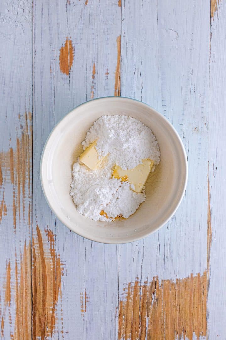 margarine, cream cheese and powdered sugar in a small white bowl