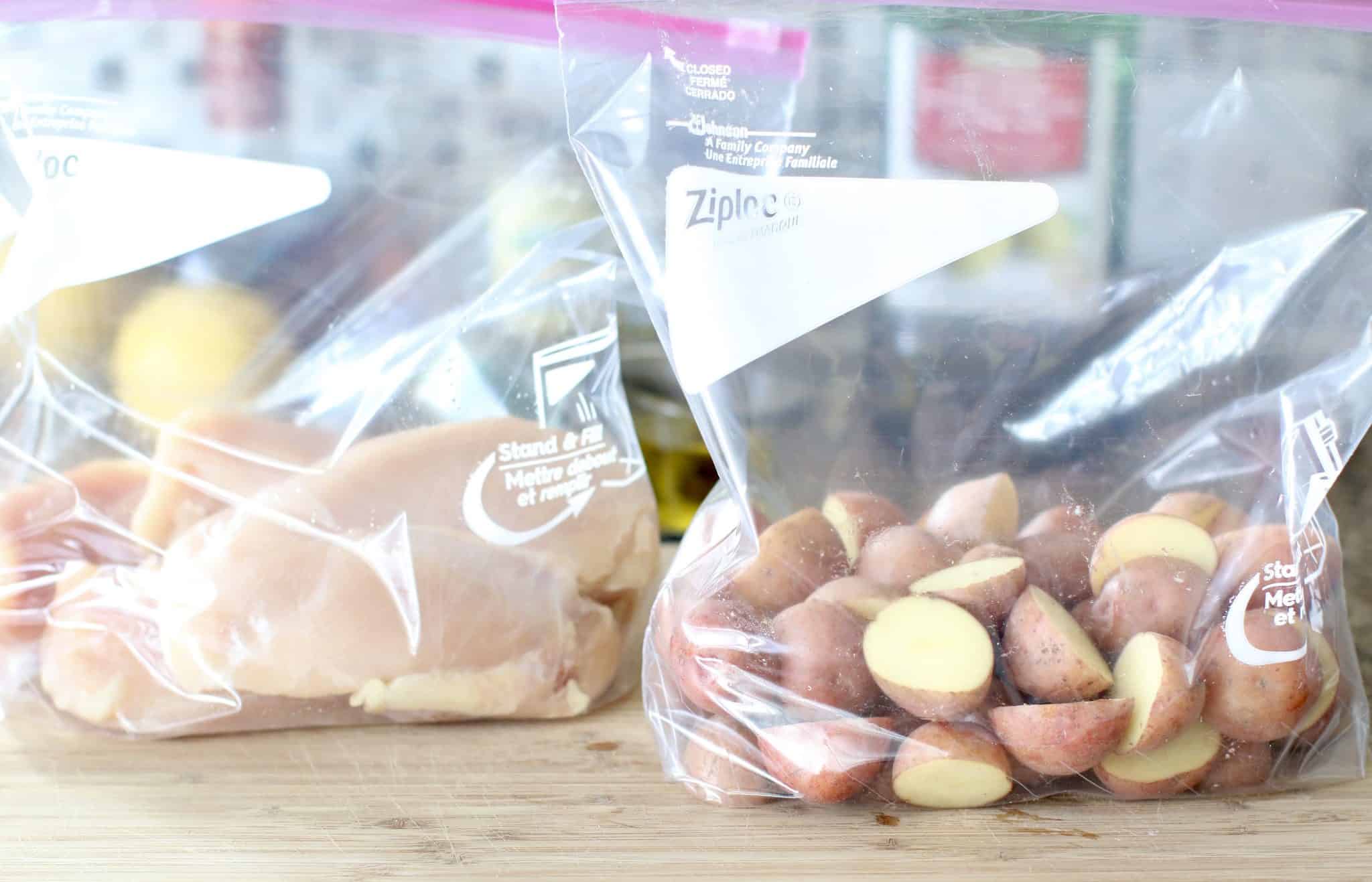 chicken breasts shown in a zip top bag and sliced red potatoes shown in another zip top bag