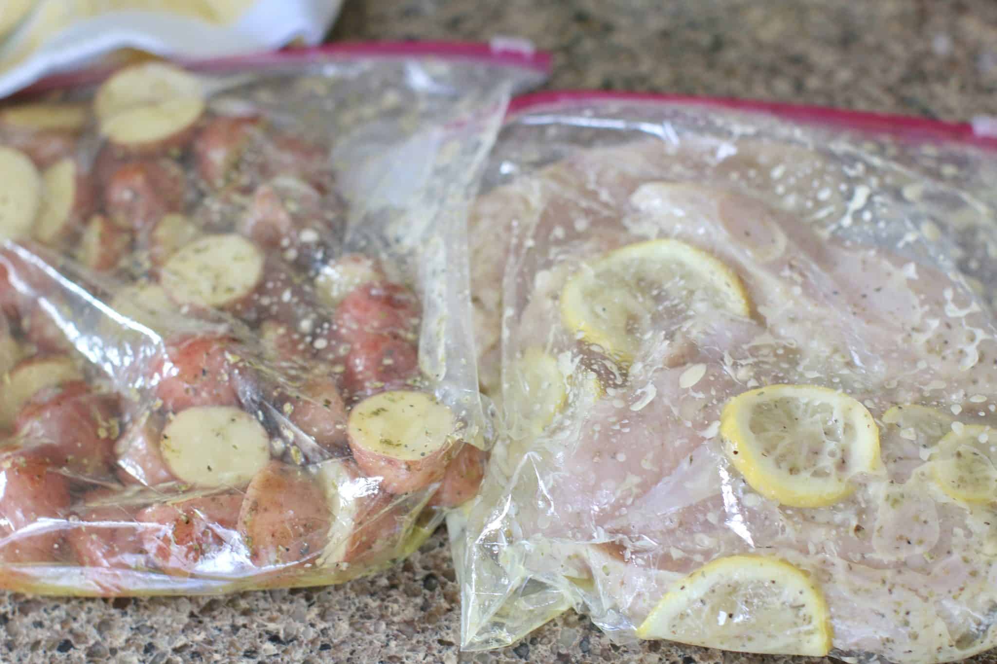 marinade shown fully saturating chicken breasts and potatoes in zip top bags.