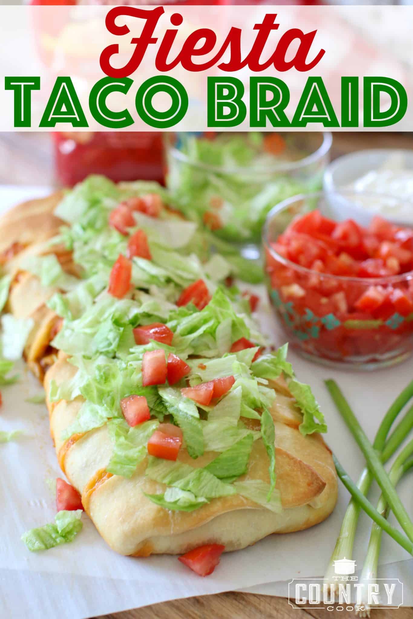 fully baked taco braid on parchment paper and topped with shredded lettuce and diced tomatoes.