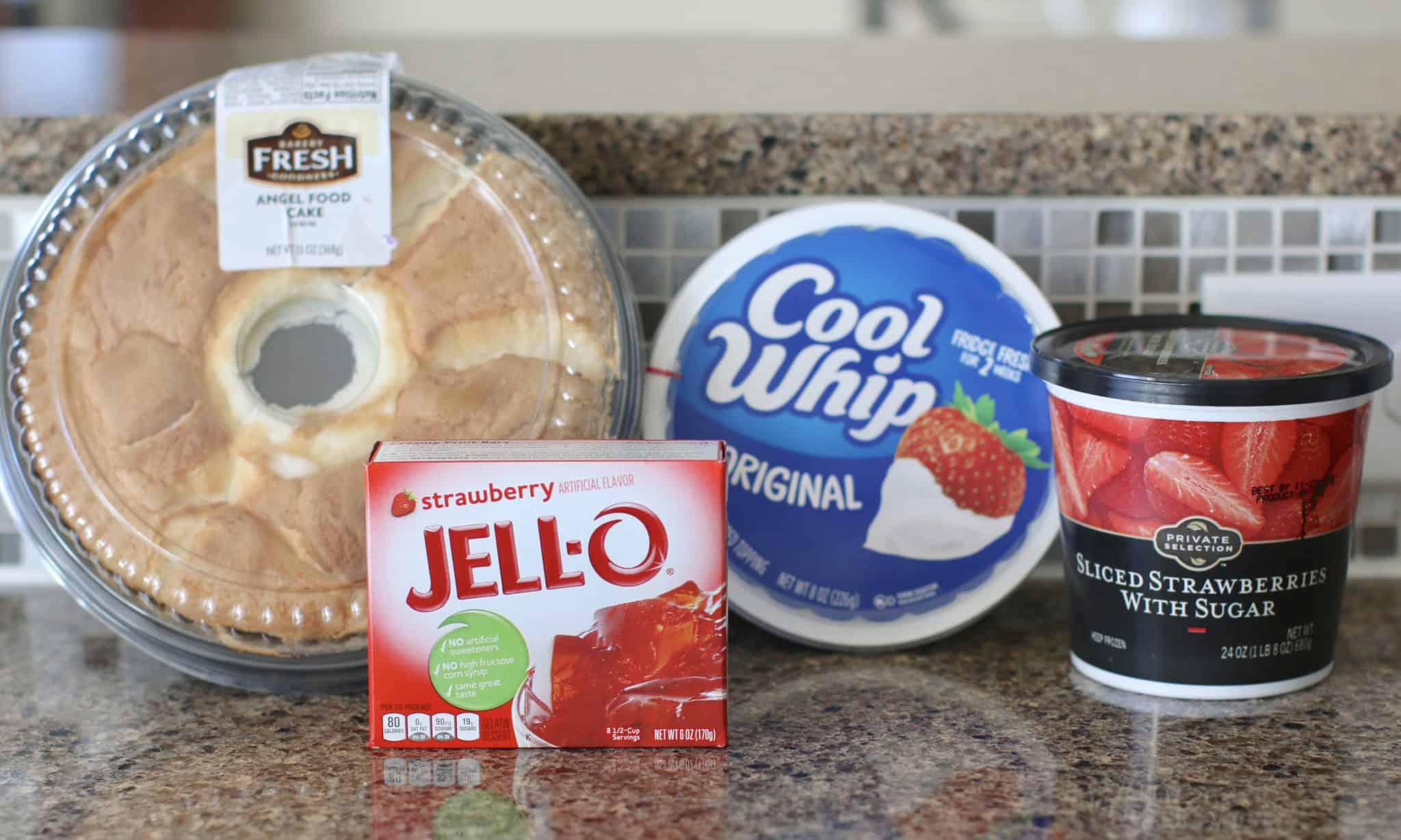ingredients needed to make no bake strawberry dessert: angel food cake, strawberry gelatin, whipped topping and sliced frozen strawberries with sugar.