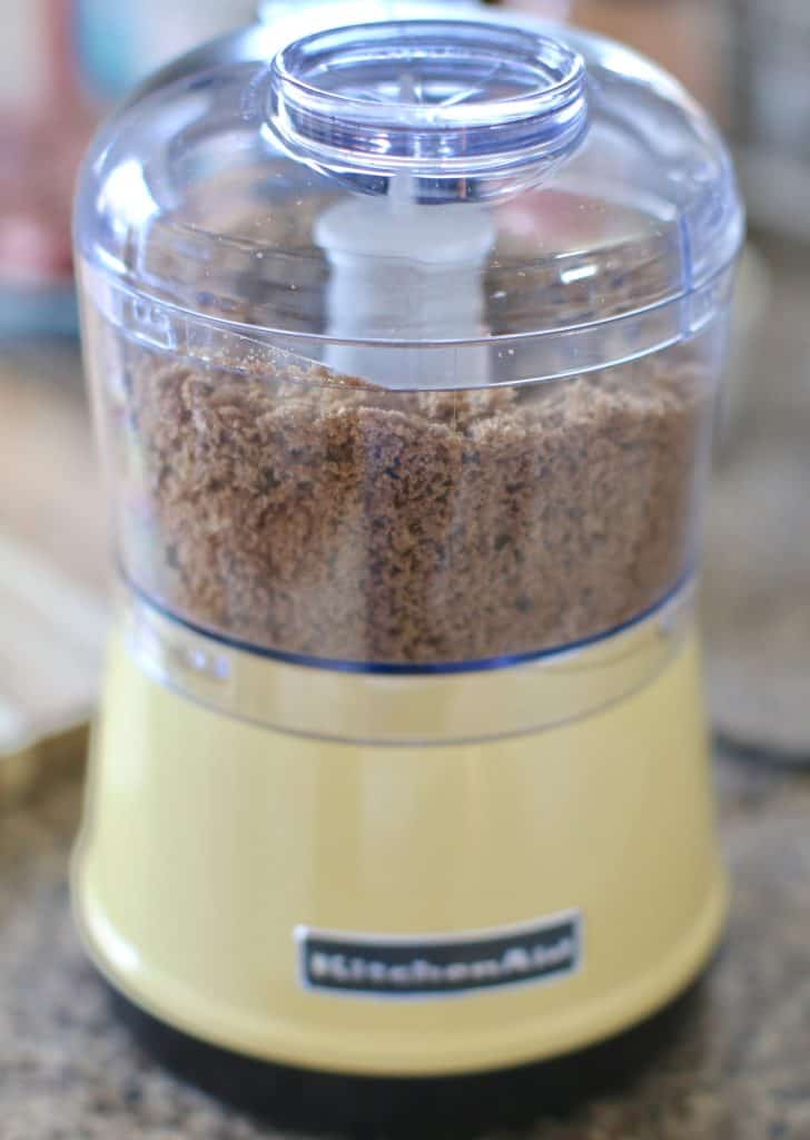 rye bread being chopped in a small food processor. 