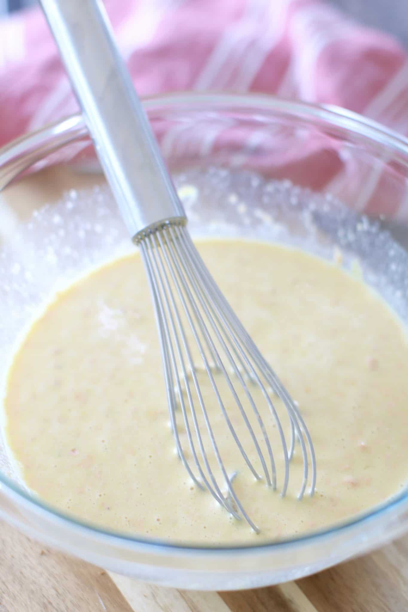 milk, eggs, Thousand Island dressing whisked together in a bowl.