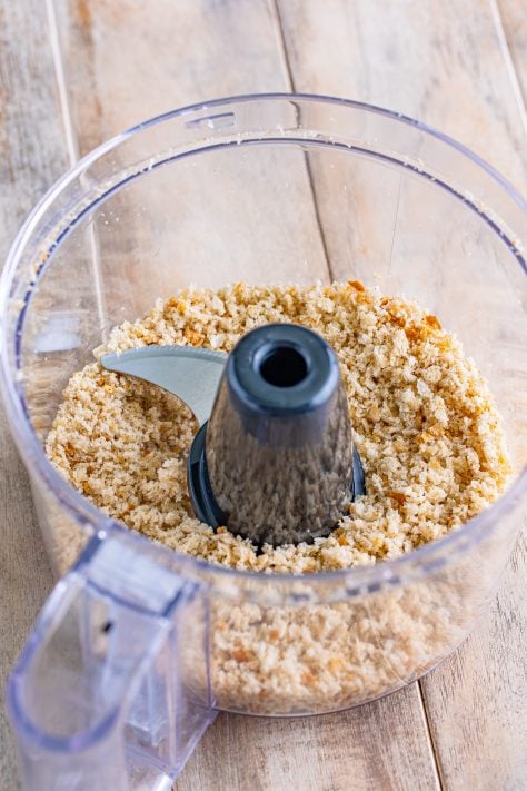A food processor with bread crumbs.
