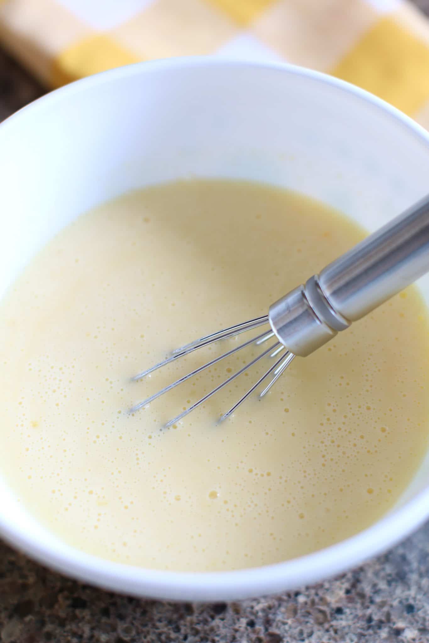 cold milk and banana instant pudding whisked together in a bowl.