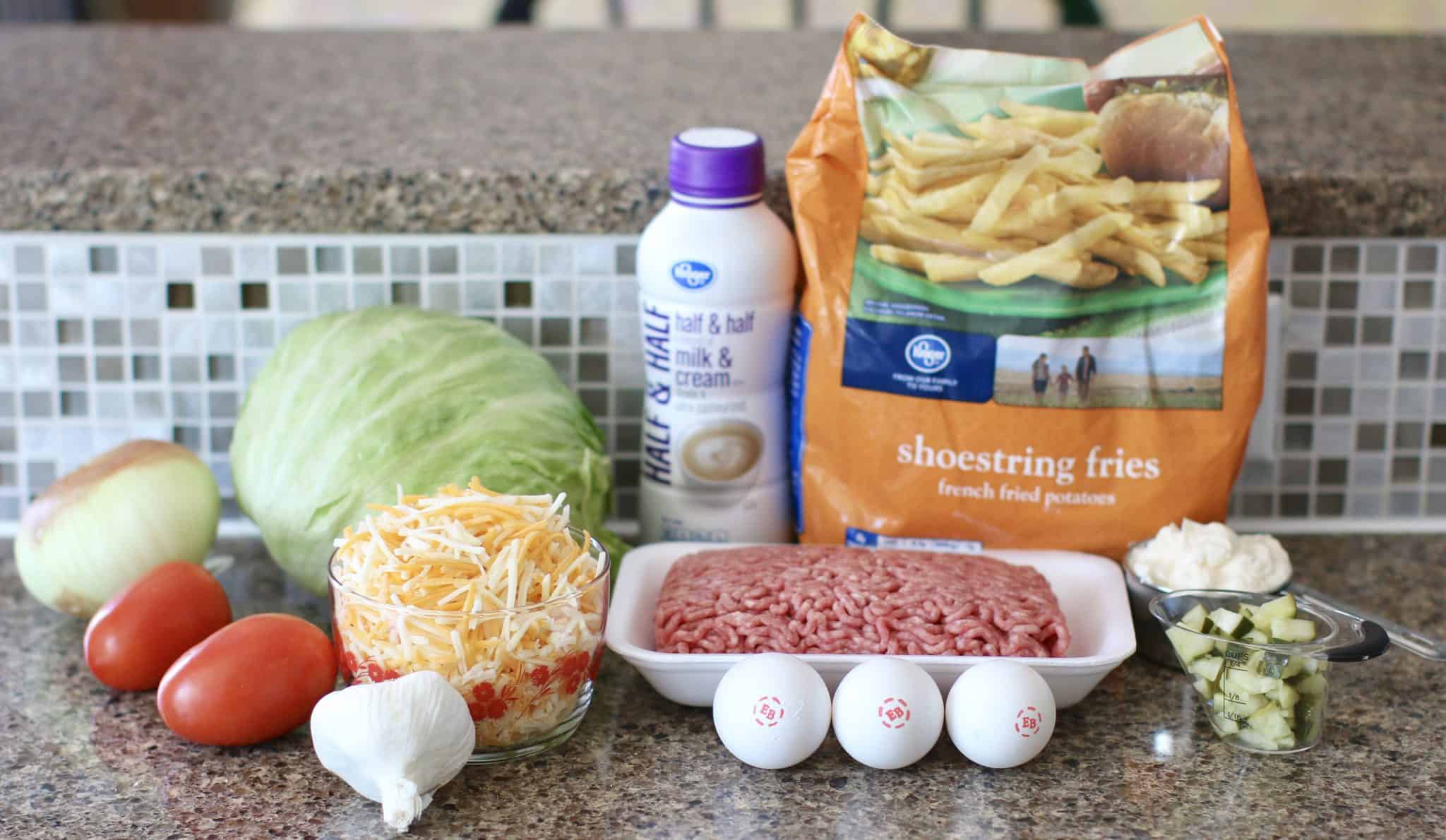 Ingredients needed to make Cheeseburger and Fries Casserole: ground beef, salt and pepper, garlic, dill pickle, eggs, mayonnaise, half and half, shredded cheese, frozen French fries.