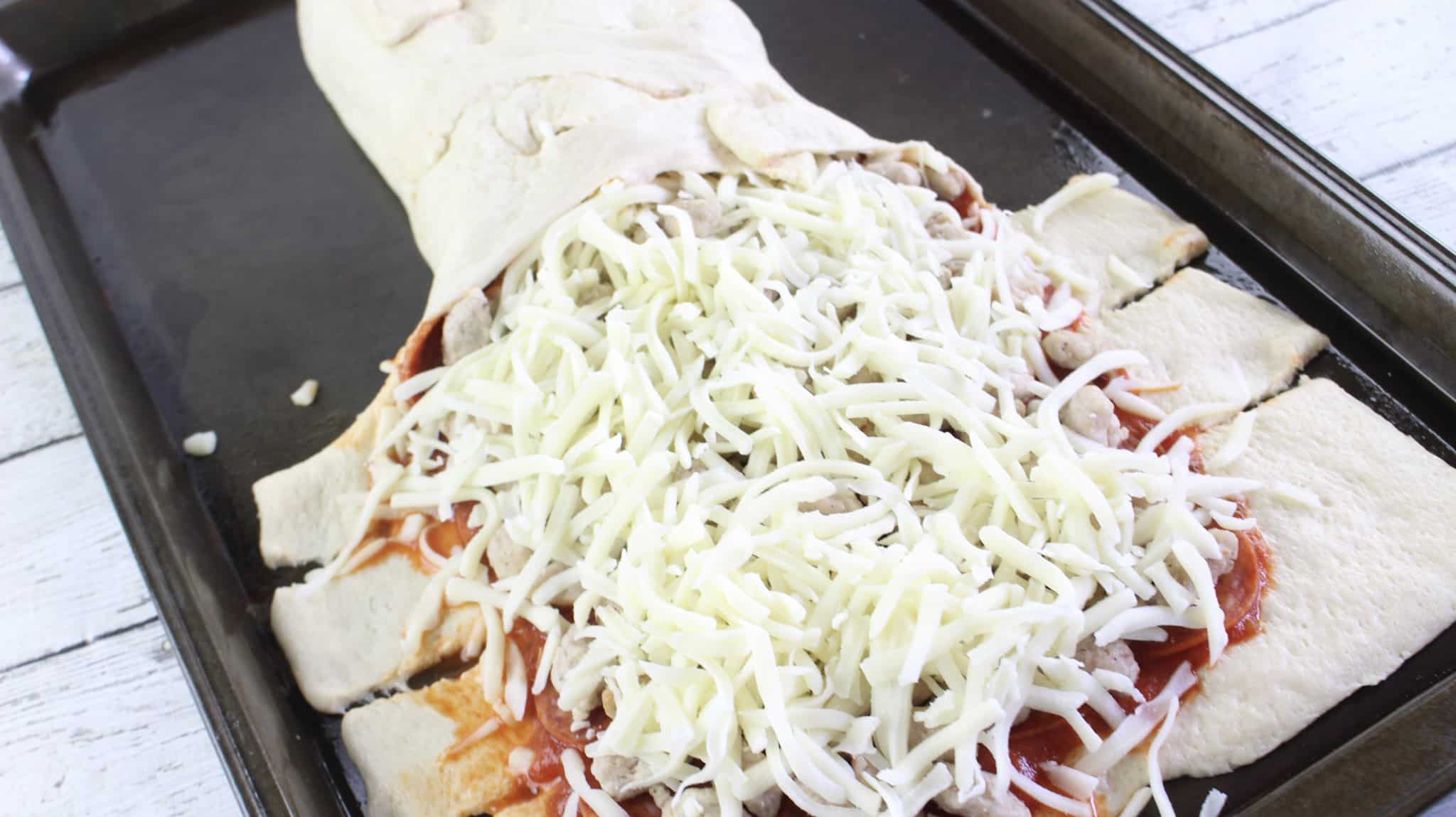 braiding pizza dough over the filling.