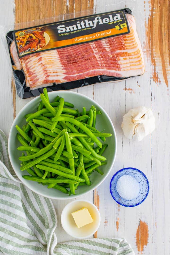 ingredients for skillet bacon garlic green beans: slices of bacon, fresh green beans, butter, garlic and salt