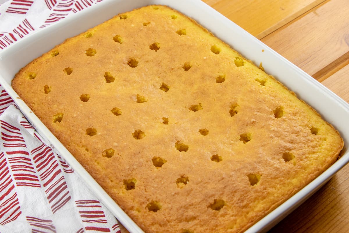 evenly spaced holes poked in fully baked lemon cake mix.