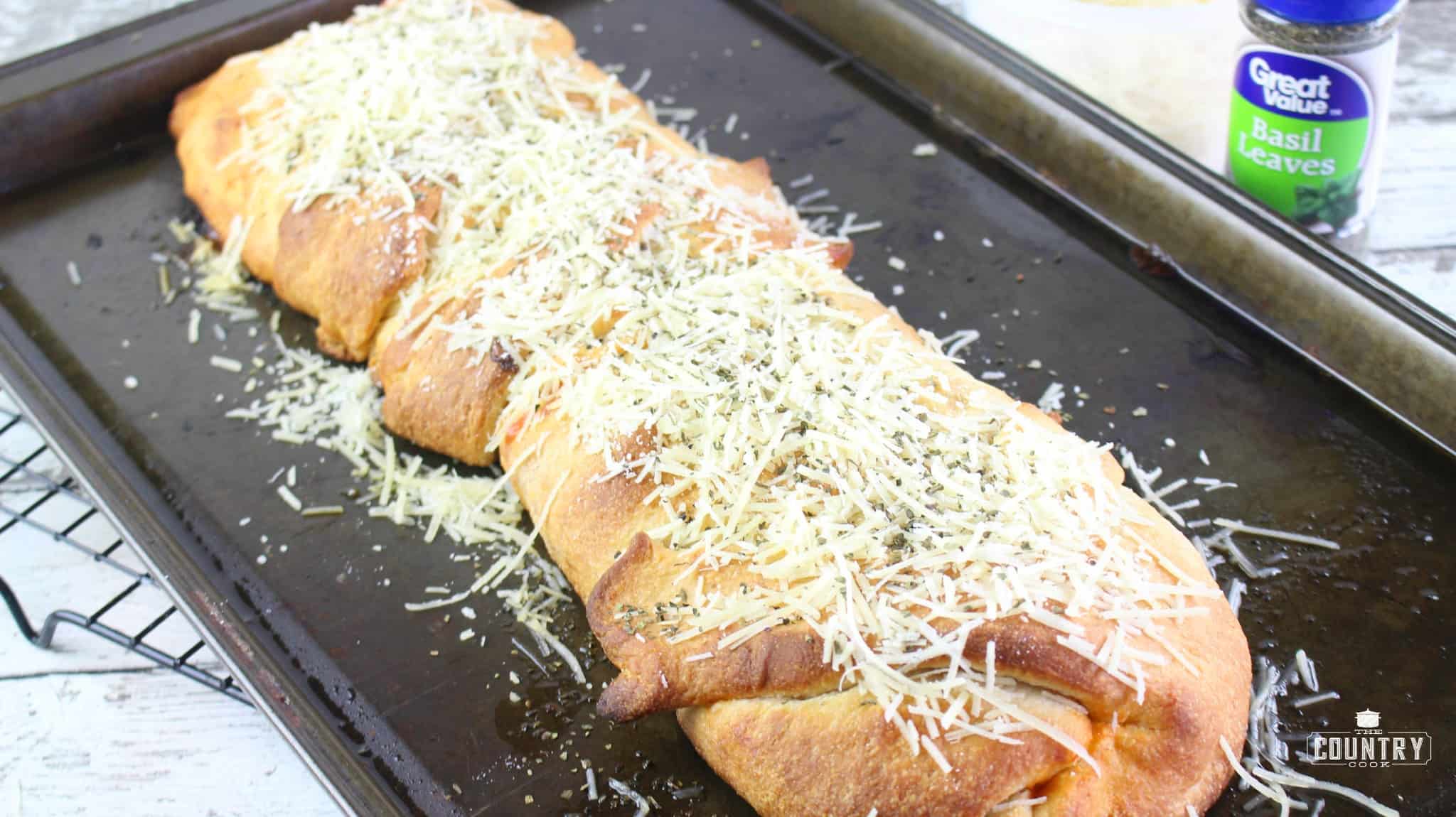 baked Stromboli topped with shredded Parmesan cheese.