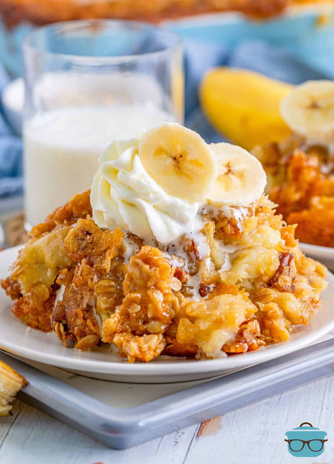 Banana Cobbler serving shown on a white plate and topped with sliced bananas