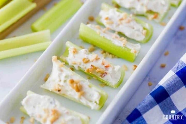 tray of celery stuffed with cream cheese, vegetable soup mix and topped with walnuts.
