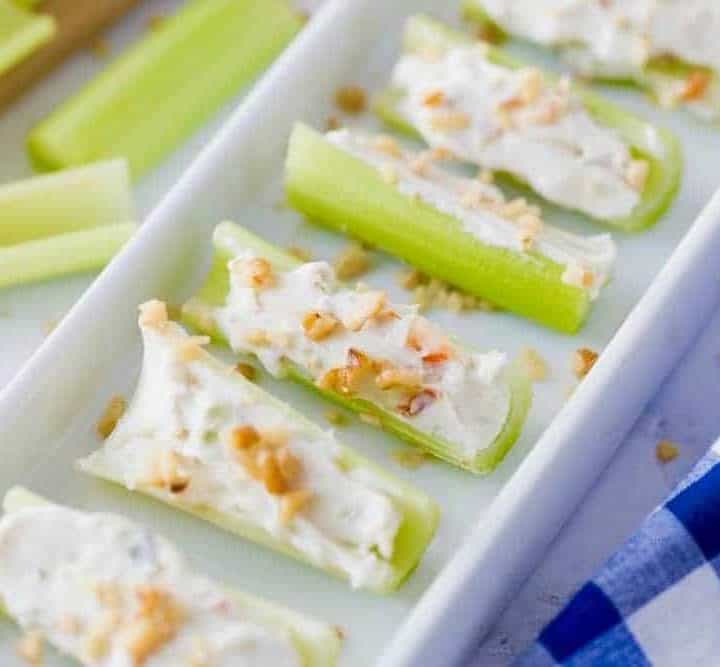tray of celery stuffed with cream cheese, vegetable soup mix and topped with walnuts