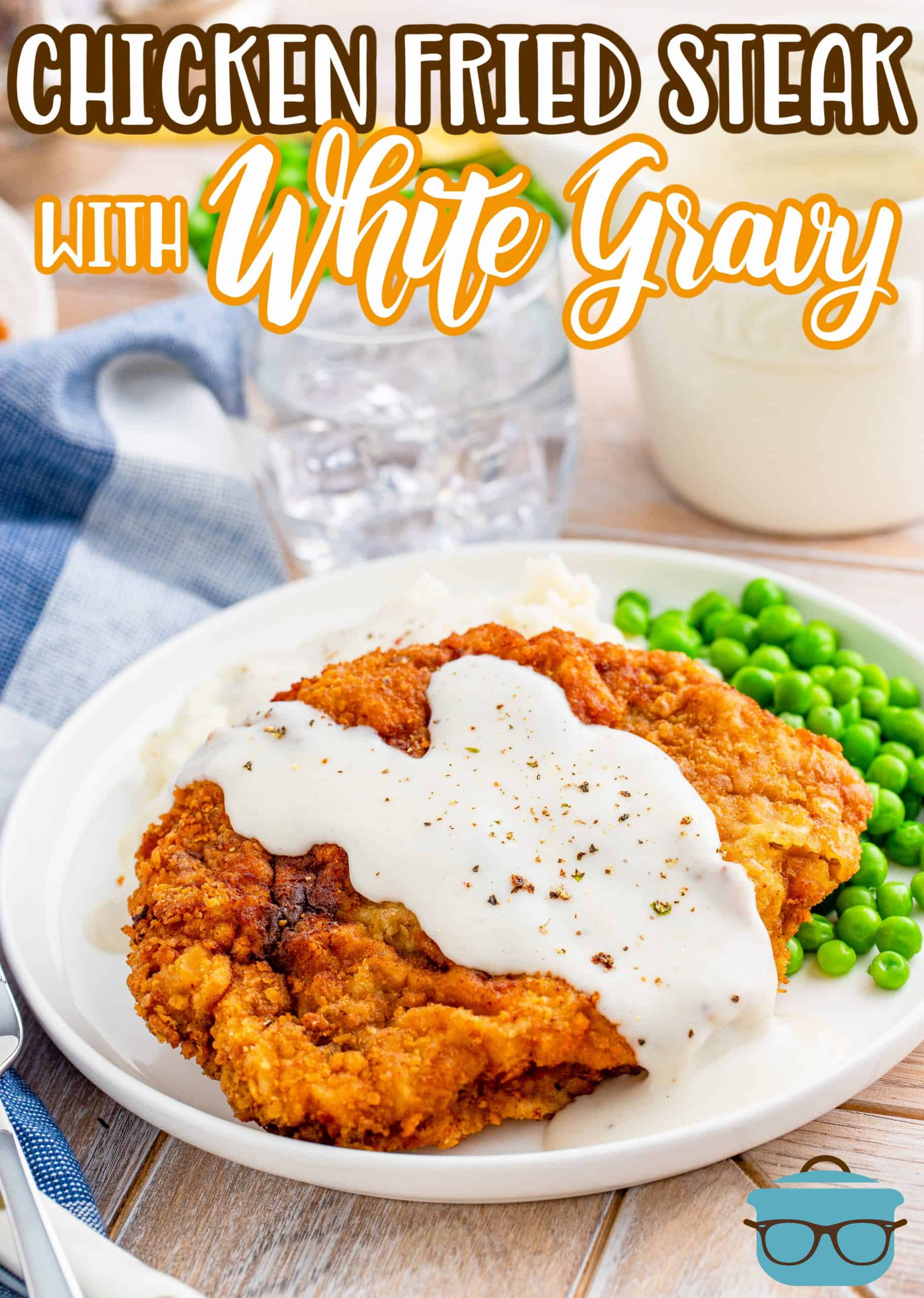 Chicken Fried Steak with Sawmill Gravy recipe from The Country Cook, shown on a plate with peas and mashed potatoes.