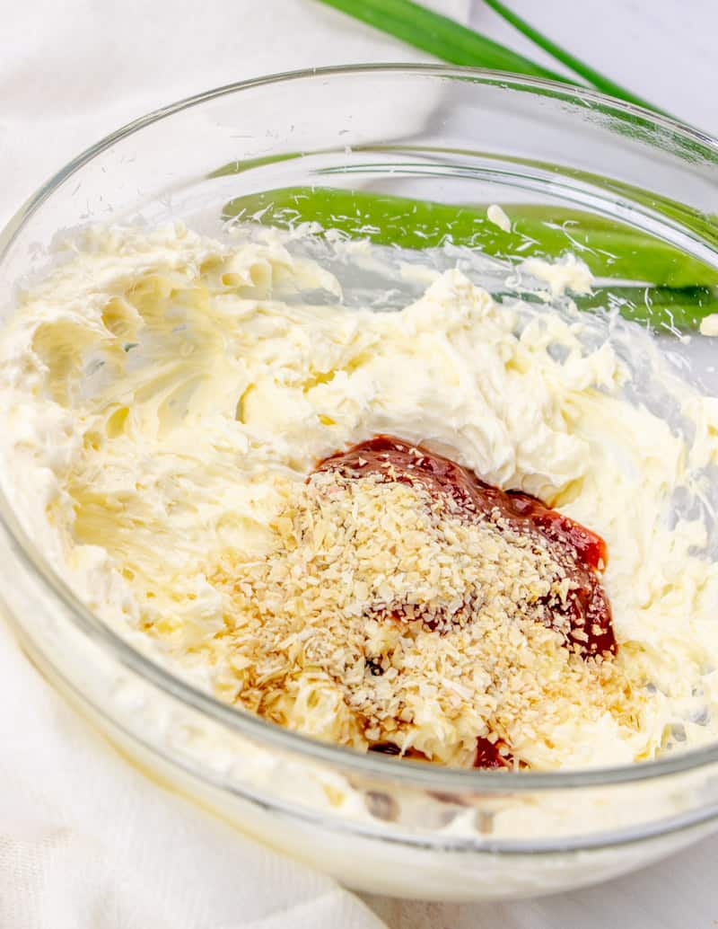 chili sauce, lemon juice, Worcestershire sauce and dried onion flakes added to mayonnaise and cream cheese mixture in a mixing bowl.