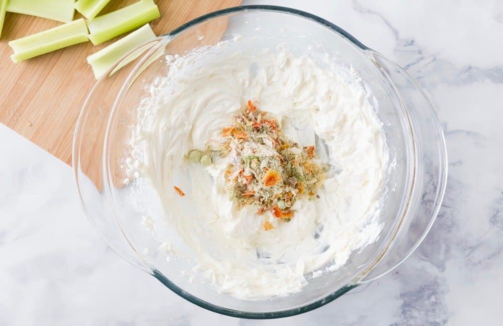 cream cheese and vegetable soup mix in a clear bowl.