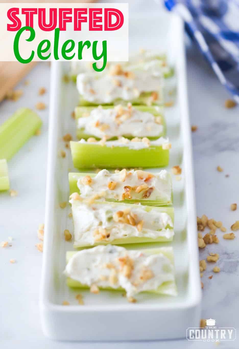 Stuffed Celery recipe from The Country Cook. Celery shown laid out in a row on a white platter. 