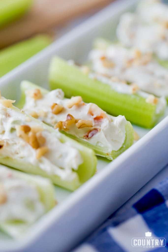 Celery stuffed with cream cheese and topped with chopped walnuts