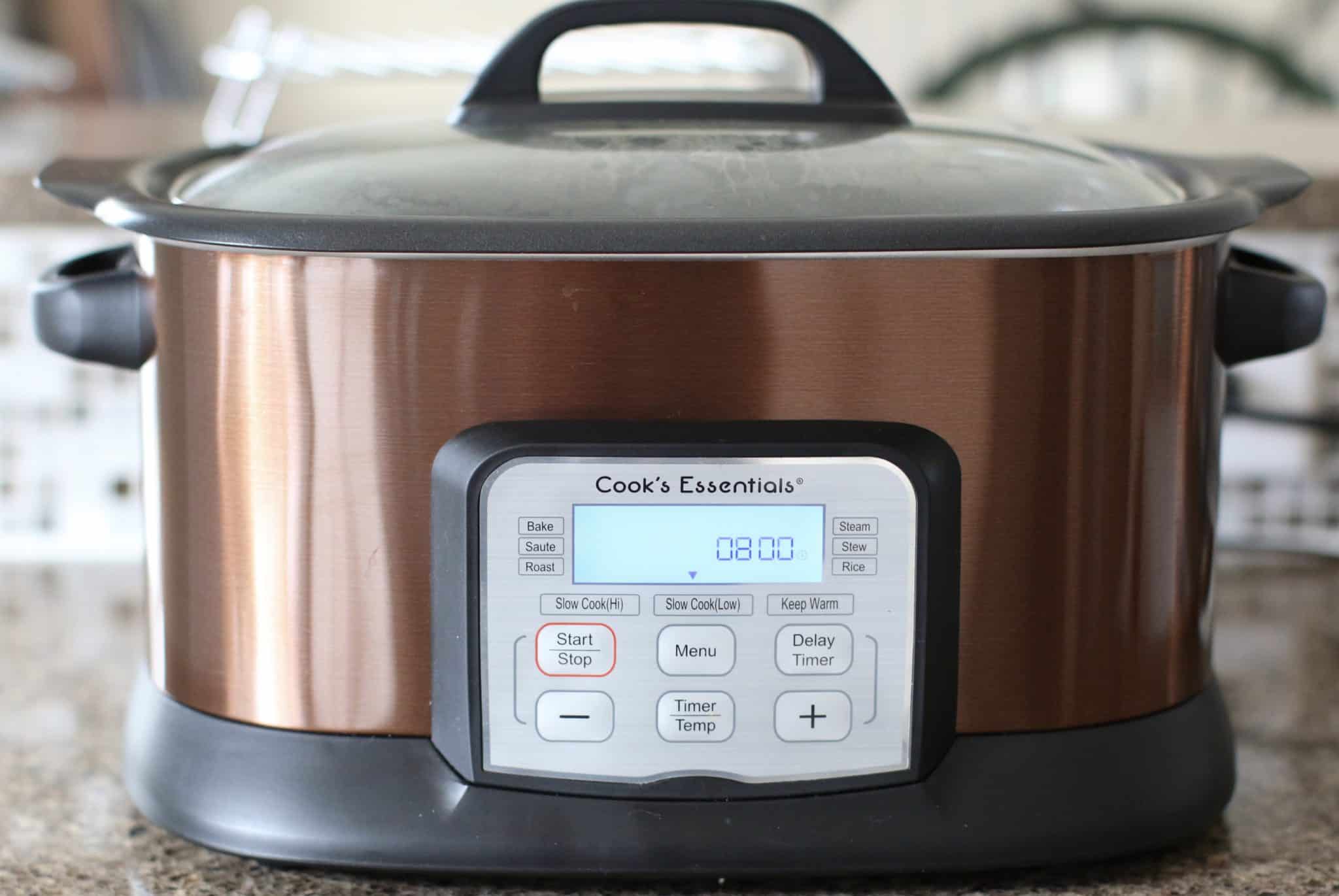 Cook's Essentials slow cooker with lid and the digital timer showing 8 hours.