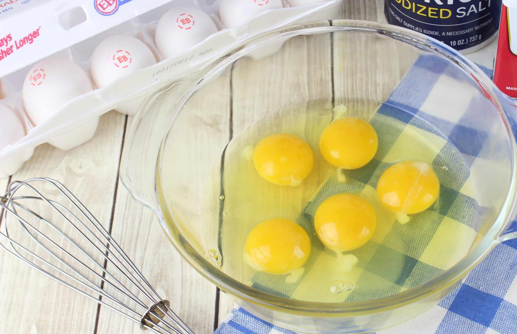 cracked eggs in a clear bowl.