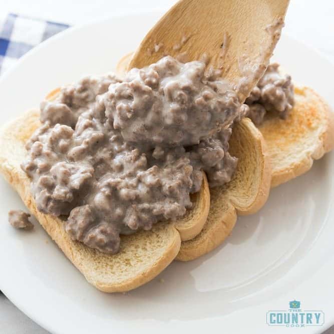 creamed hamburger gravy with milk shown served over three pieces of toast.