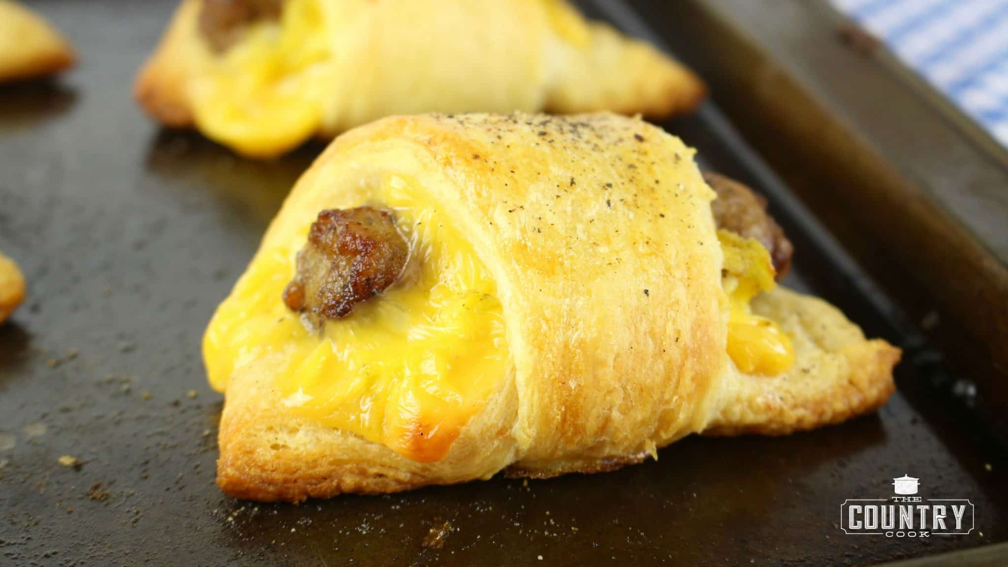fully cooked breakfast rolls on a baking sheet.