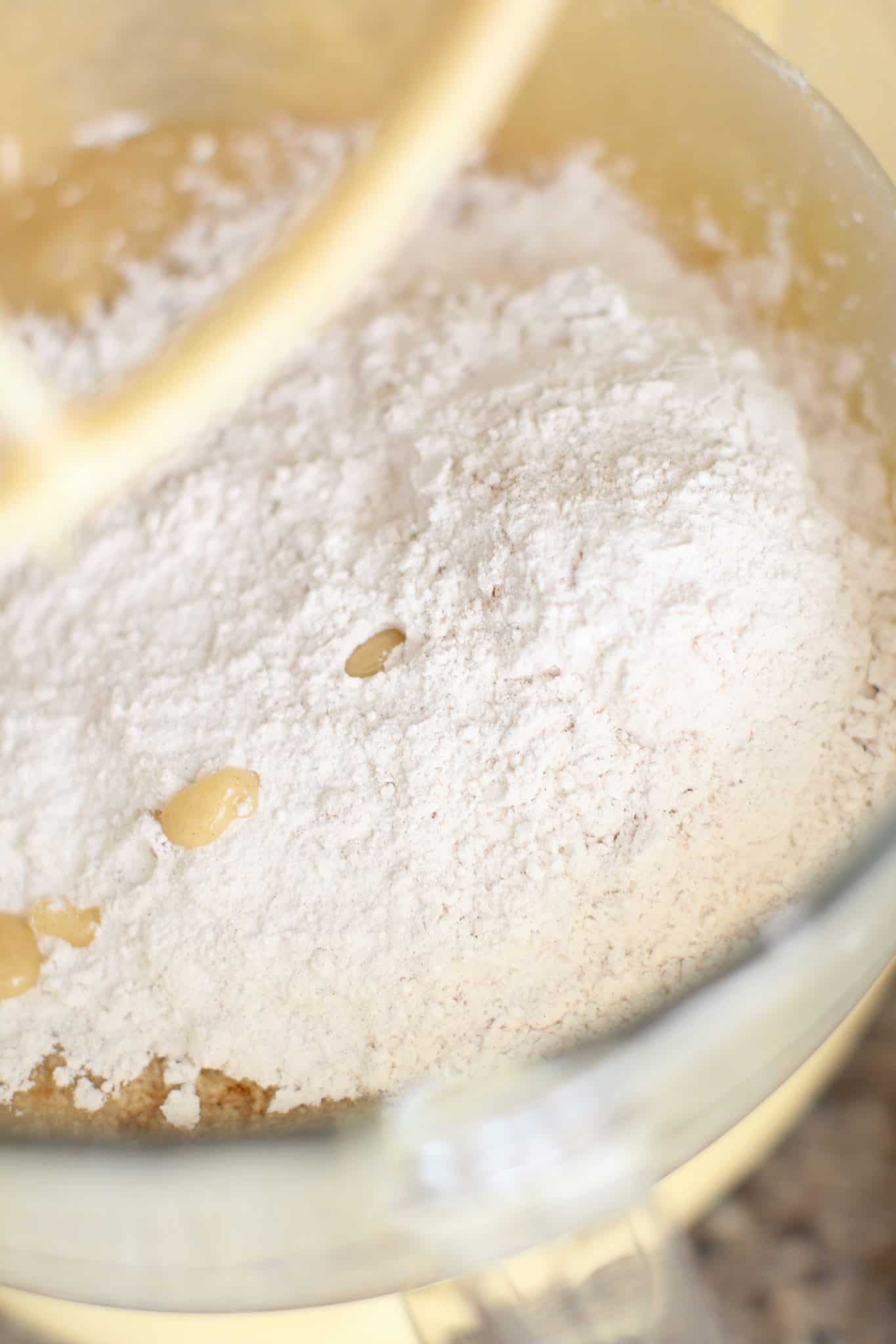 adding all-purpose flour into mixing bowl.