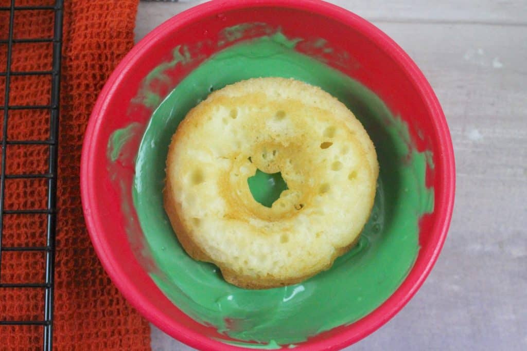 dip baked doughnuts in melted green candy