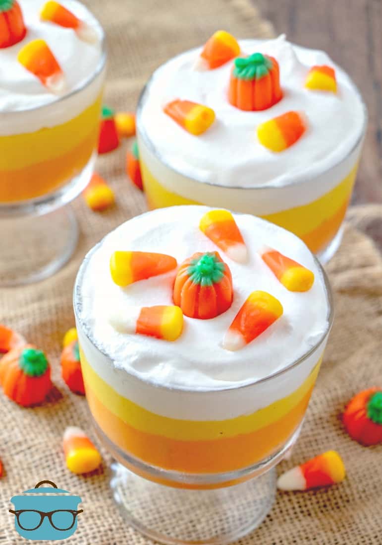 Candy Corn Pudding Parfaits topped with candy corn candy and mallow creme pumpkins.