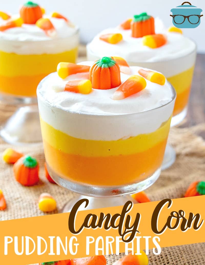 Easy Candy Corn Vanilla Pudding Parfait recipe from The Country Cook. Close up photo of one of the parfaits with candy pumpkins and candy corn on top.