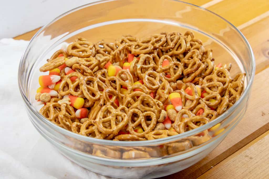 pretzels, peanuts, candy corn mixed together in a large bowl