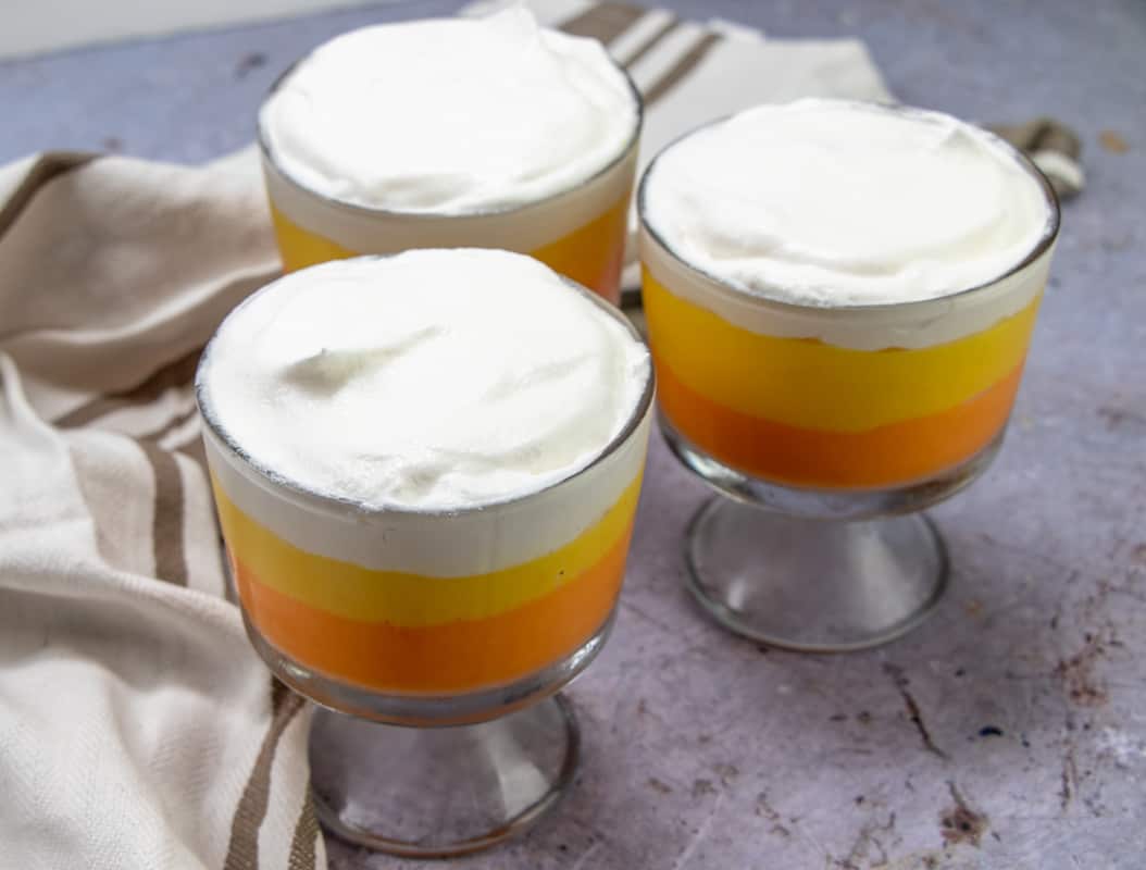 Cool Whip (whipped topping) spooned on top of cooled pudding parfaits.