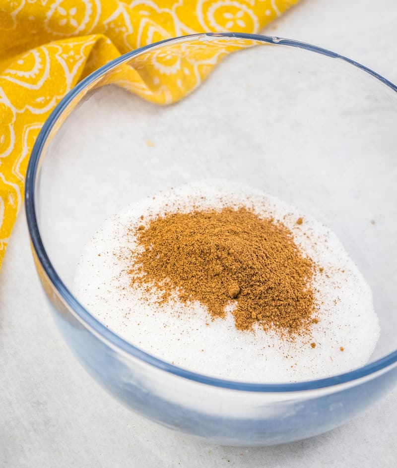 sugar and pumpkin pie spice combined in a glass bowl