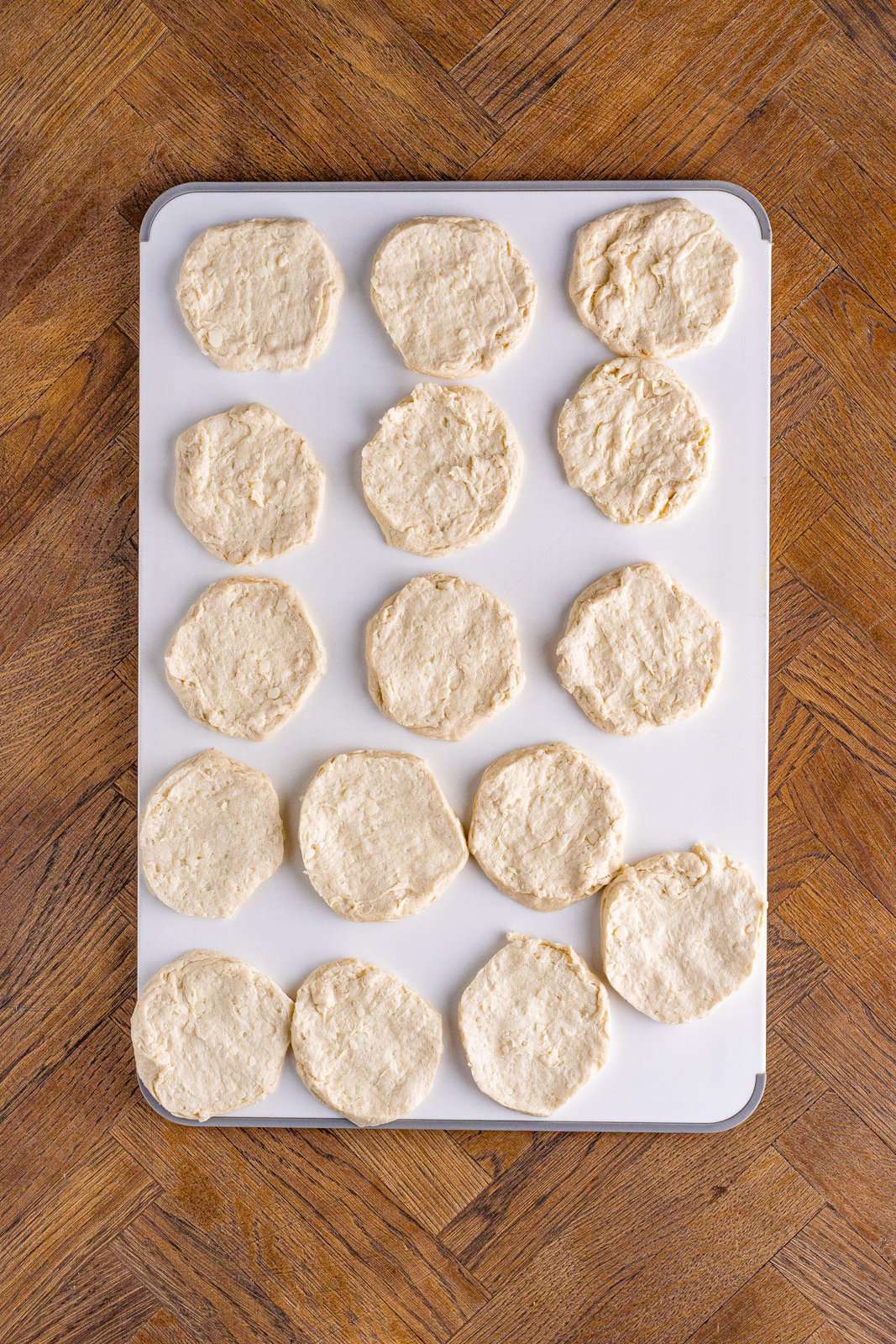biscuits shown split in half on a white cutting board. 