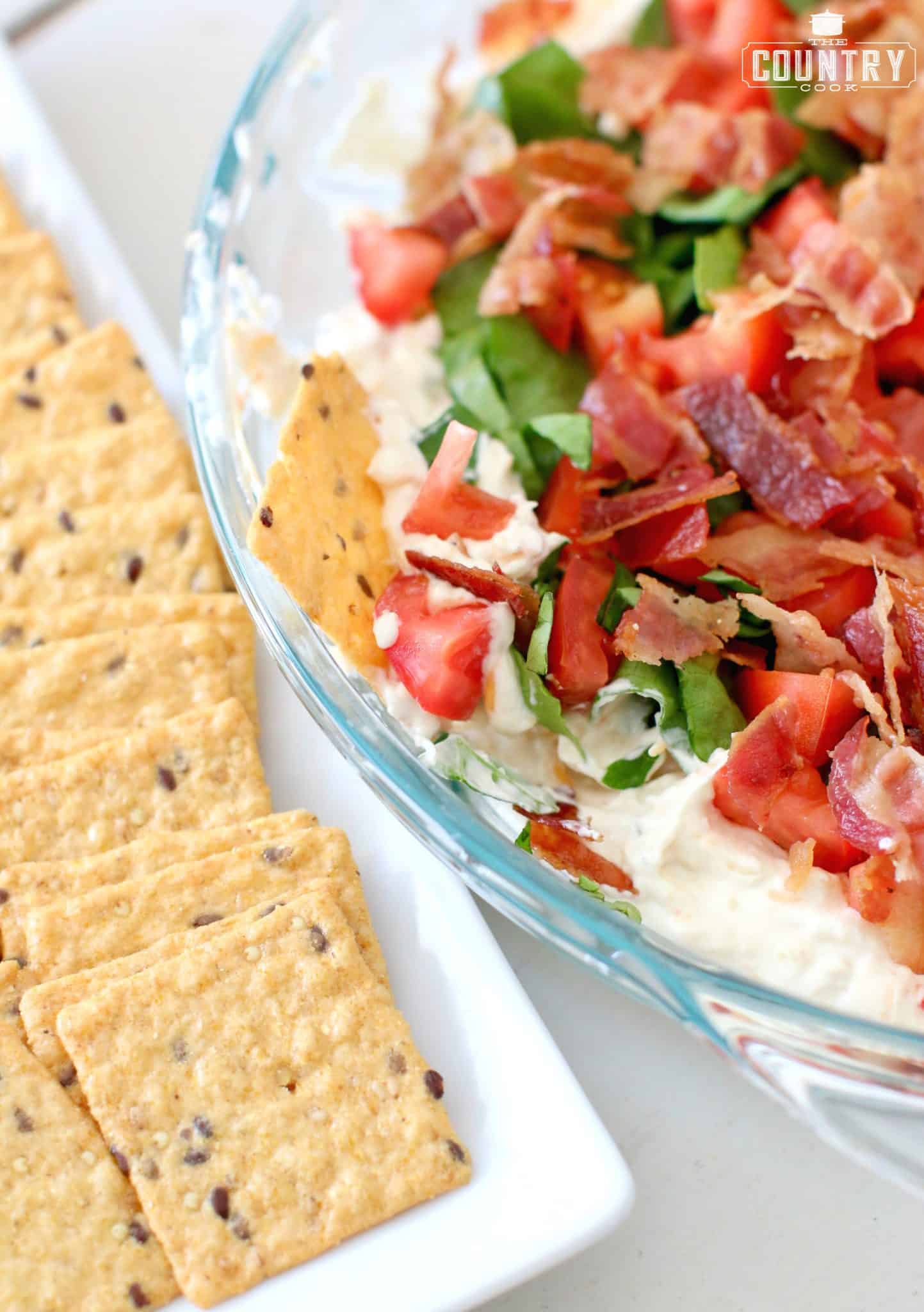 a cracker shown pressed into the BLT dip.